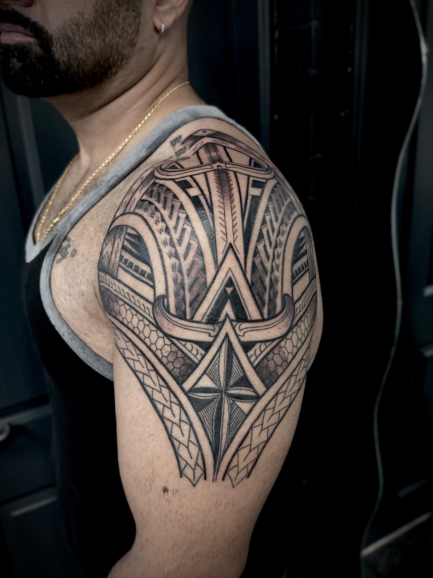 Black and grey tribal shoulder piece by Steve Evans