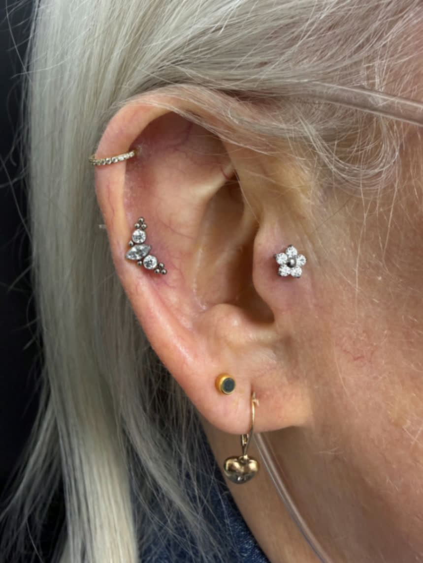 Curated ear with floral conch jewellery, crystal cluster flat piercing and gold lobe styling