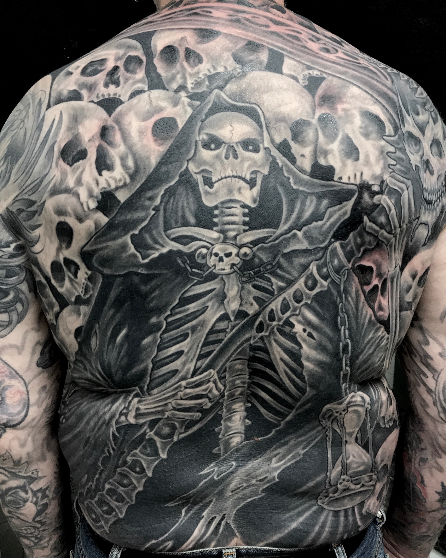 Black and grey grim reaper and skulls full back piece by Steve Evans