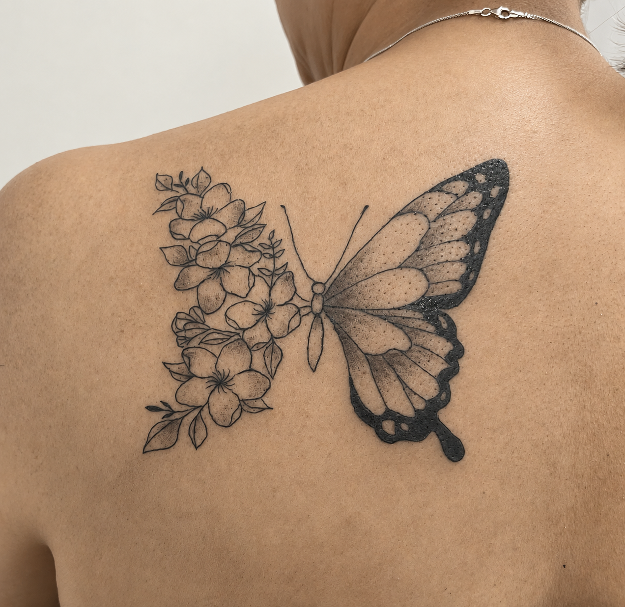 Butterfly and floral back tattoo by Clare