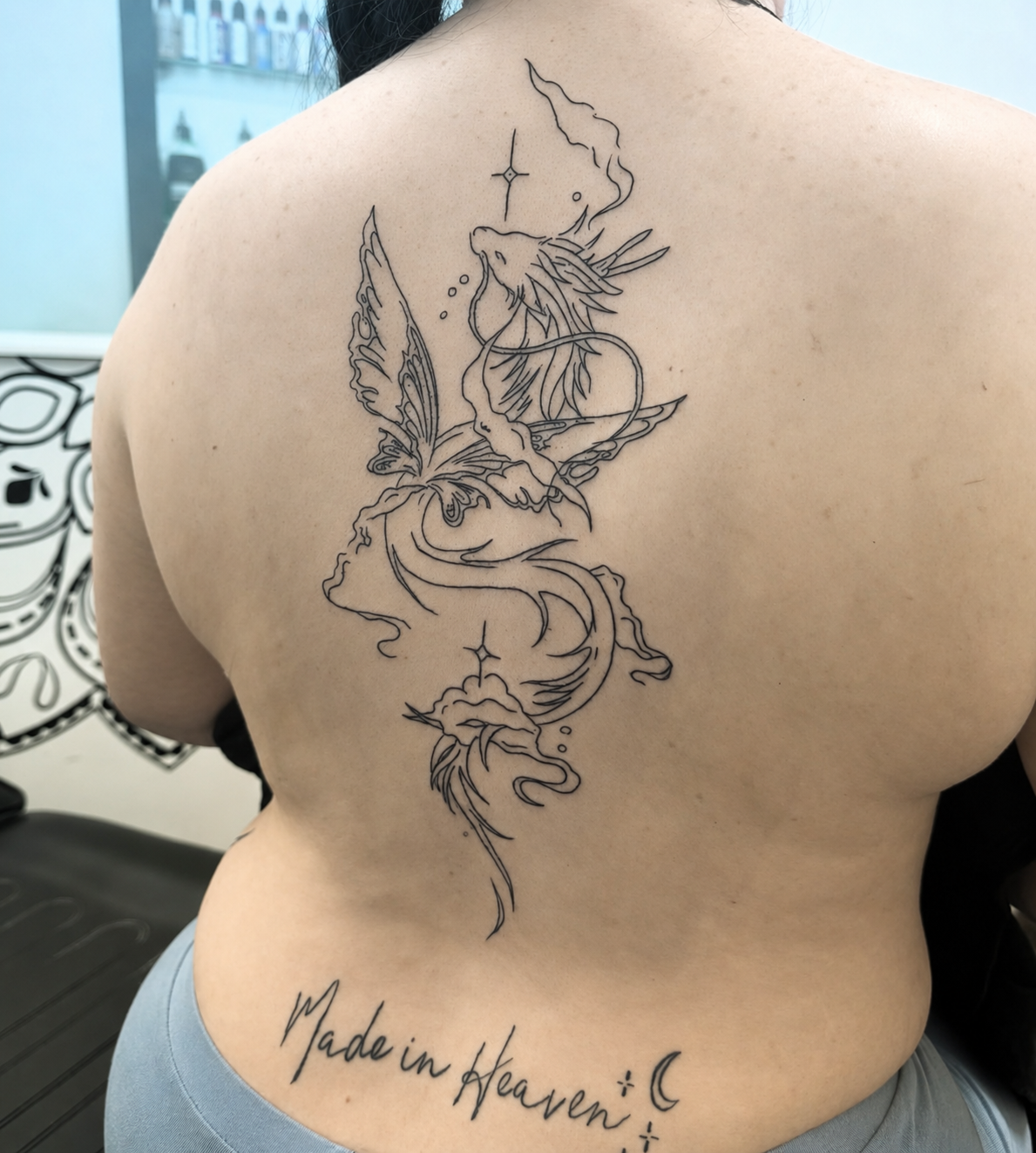 Fine line fairy back tattoo by Clare