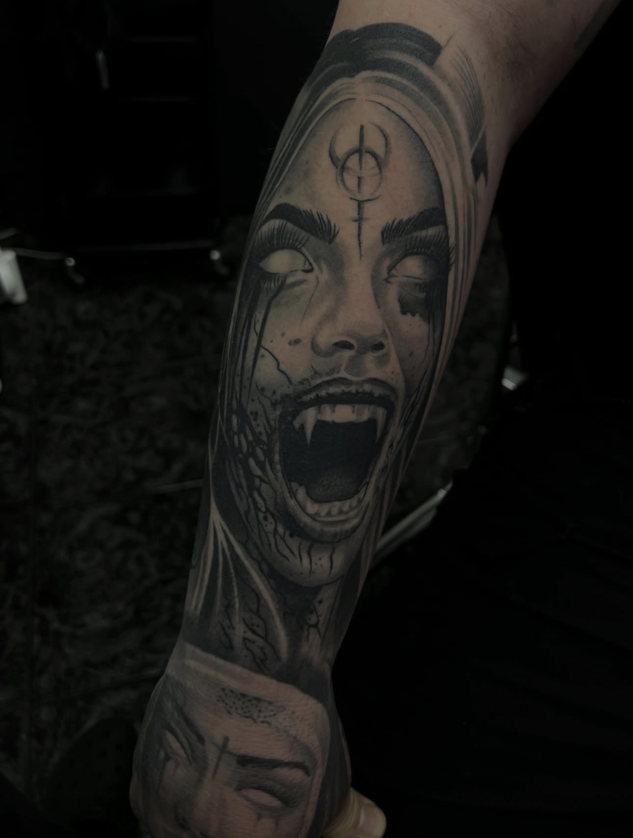Black and grey realism vampire woman with fangs forearm sleeve by Danny Birch