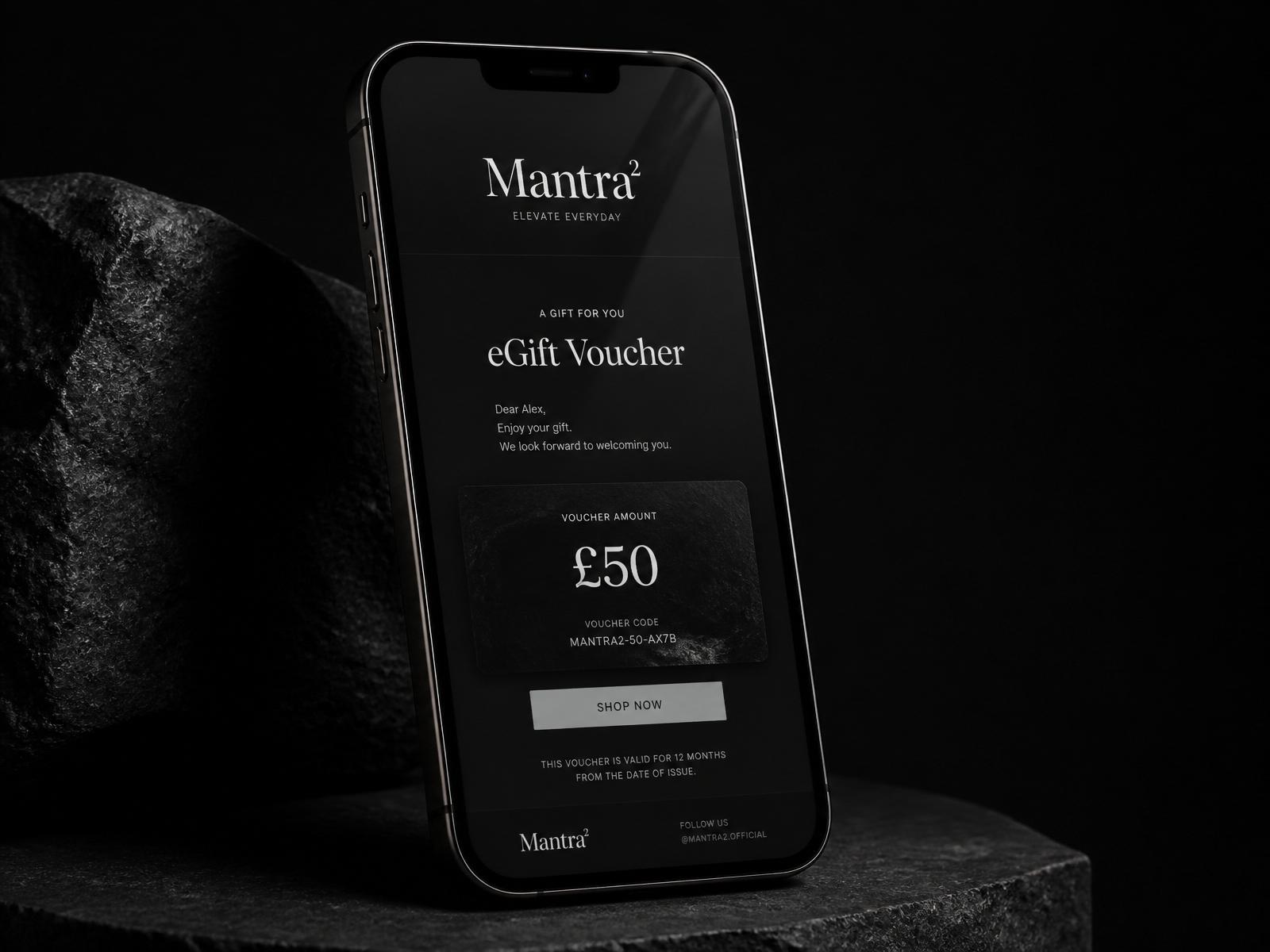 Smartphone displaying a Mantra² eGift Voucher on a matte black surface