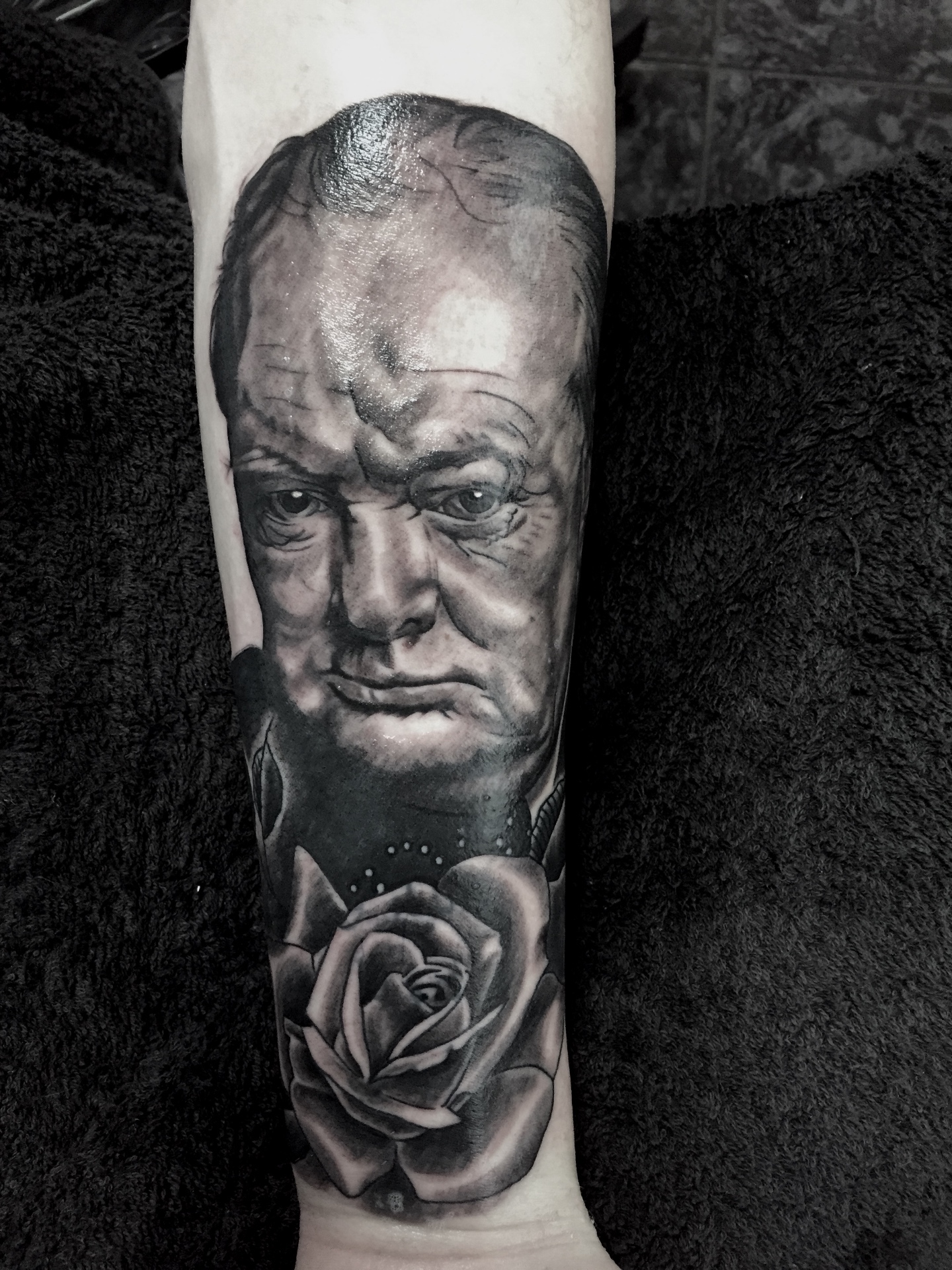 Black and grey Winston Churchill portrait and rose forearm tattoo by Steve Evans